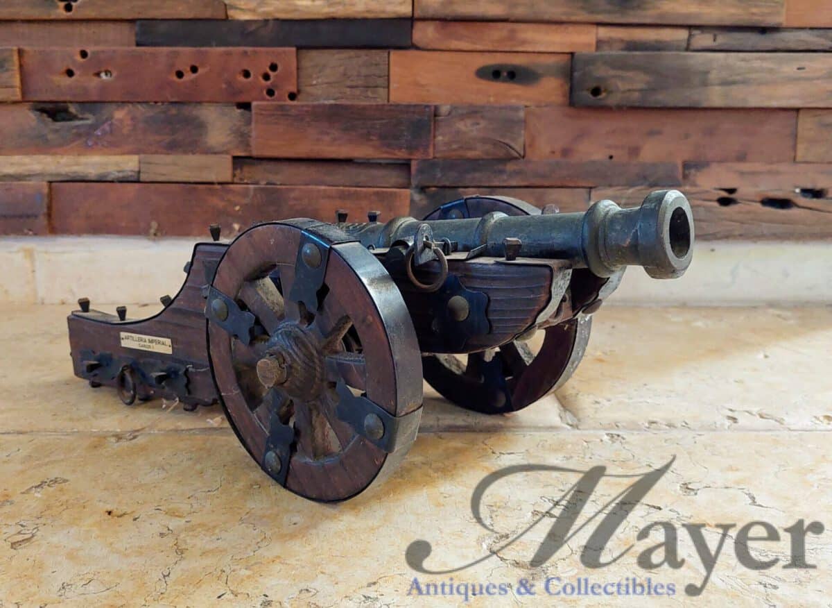 Small vintage replica Spanish cannon on wooden carriage with plaque stating "Artilleria Imperial Carlos I"