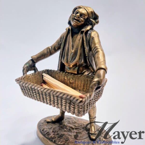 Antique bronze matchstick holder of Belgian peddler